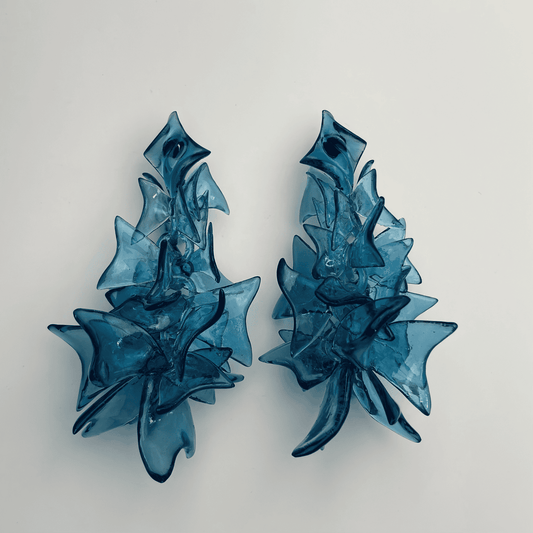 Blue fashion jewelry worn by model, demonstrating the bold size and drop