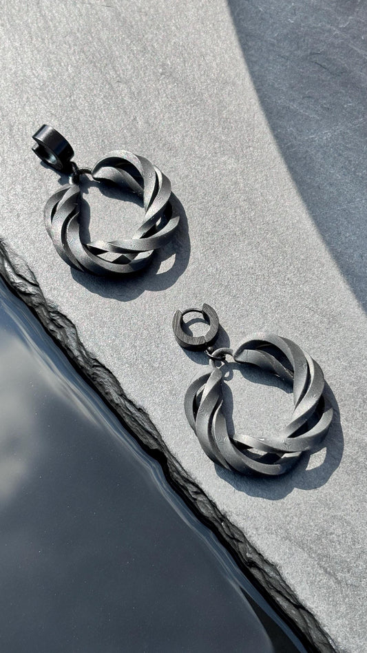 Side profile of contemporary costume jewelry hoops showing the infinite loop.