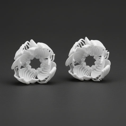 Two large, complex 3D printed stud earrings shaped like voluminous white flowers, resting on a black background.