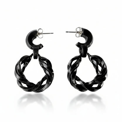 Black hoop earrings on a white background
