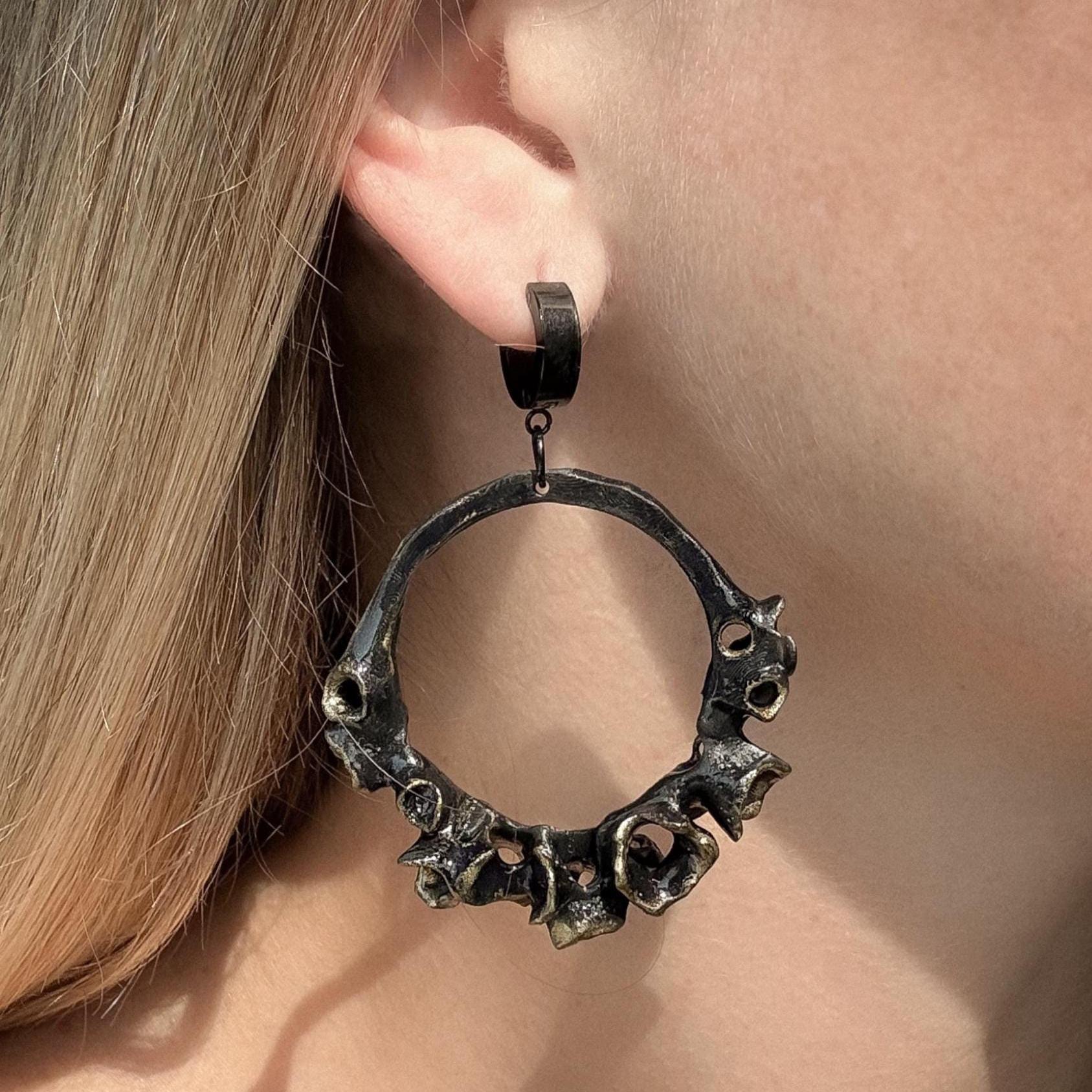 Close-up of a black hoop earring on the model