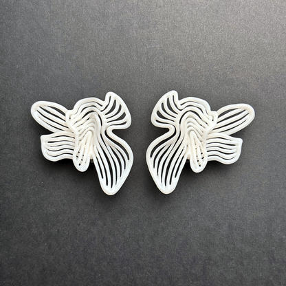 Butterfly-shaped earrings on a dark gray background