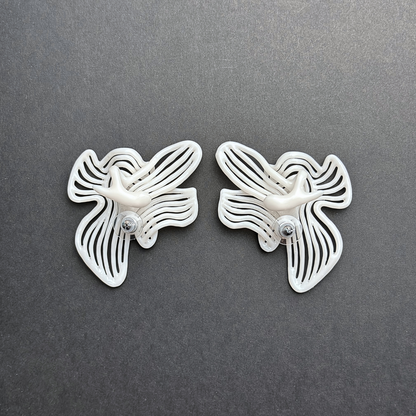 Pair of butterfly-shaped earrings on a gray background
