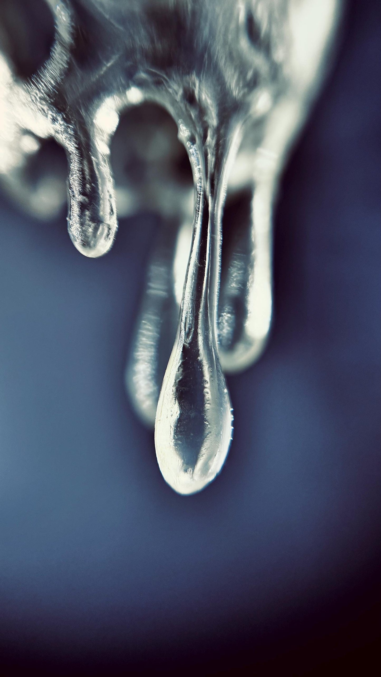 Close-up of  crystal drop 3d printed earrings against a dark background