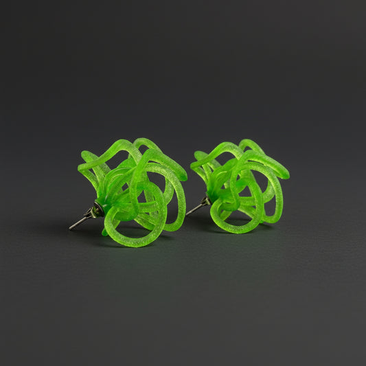 Green earrings on a dark background