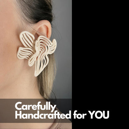 Close-up of a model's ear, showcasing a beige 3D printed Rhythm Earring with a "Carefully Handcrafted for YOU" overlay tag.