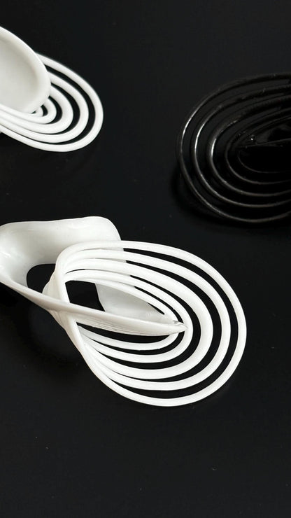 Infinity Loops Statement Earrings black and white, looks like orbits