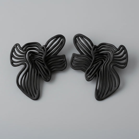 Pair of black butterfly-shaped earrings on a grey background