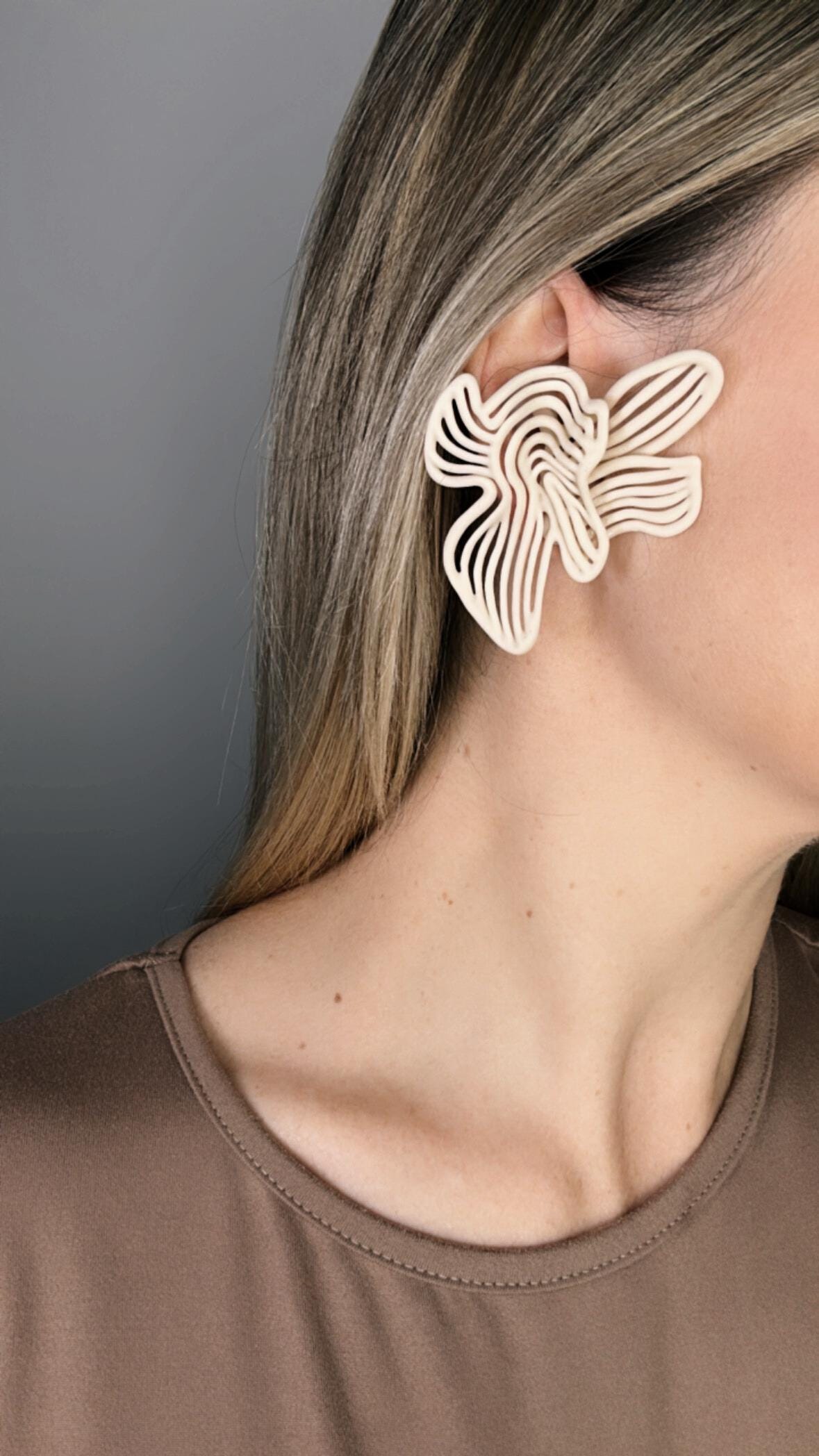 Model wearing beige Art Deco inspired Rhythm earrings for evening styling