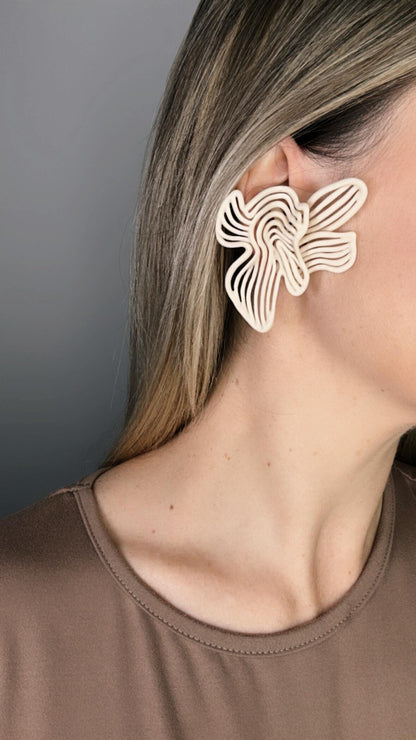 Model wearing beige Art Deco inspired Rhythm earrings for evening styling