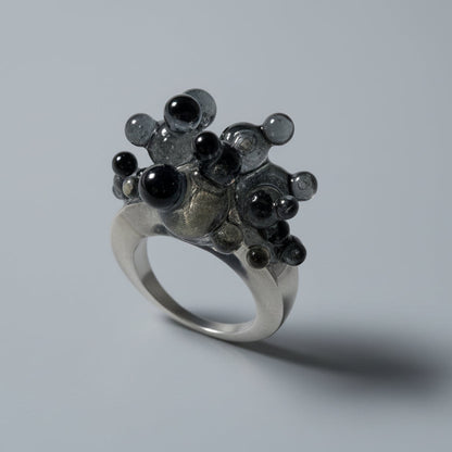 Close-up of the unique glossy spheres and smoky base of the Dark Matter artistic ring.