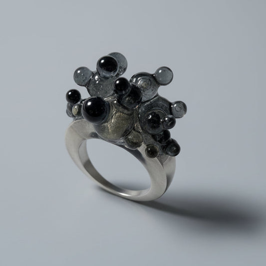 Close-up of the unique glossy spheres and smoky base of the Dark Matter artistic ring.