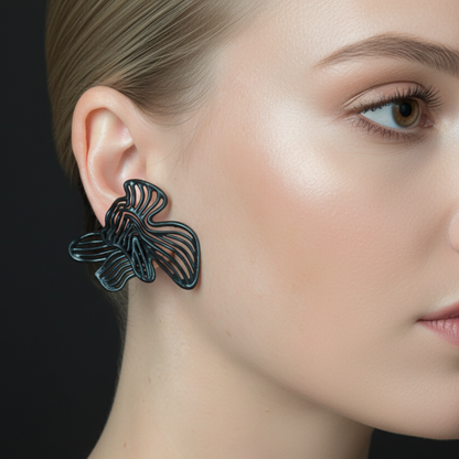 Lightweight sculptural jewelry worn by model, showing comfortable fit.