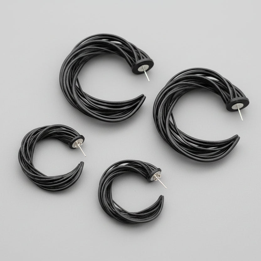 Pair of dynamic spiral earrings displayed on a clean background.
