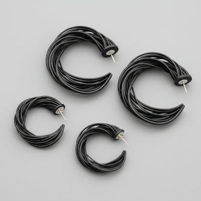 Pair of dynamic spiral earrings displayed on a clean background.