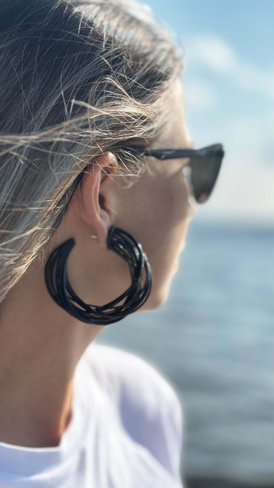 Model wearing lightweight statement spirals, showing comfortable fit and bold scale.