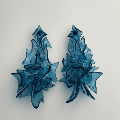 Blue fashion jewelry worn by model, demonstrating the bold size and drop