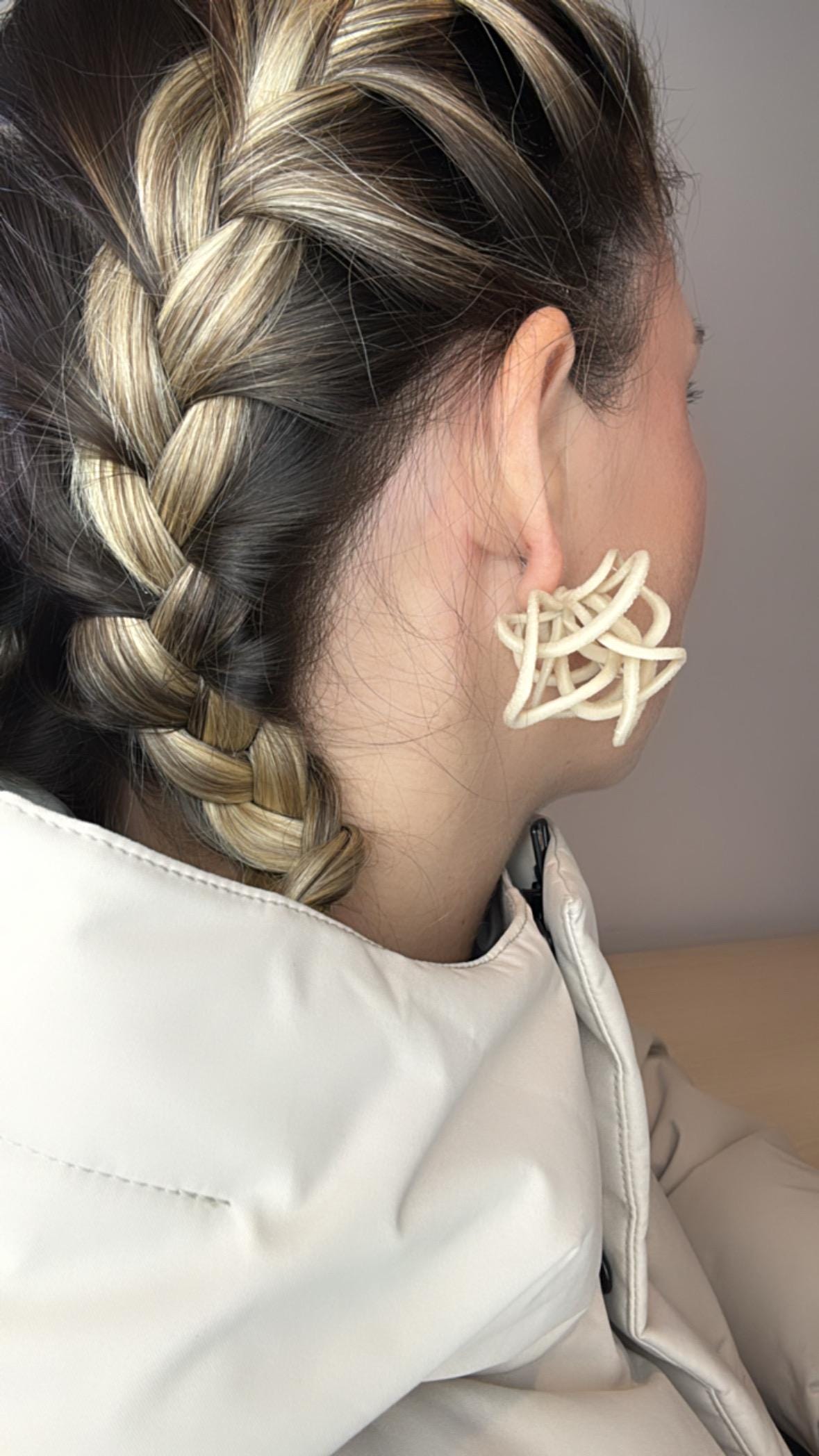 Model wearing Ivory Celestial Loops, side profile with braided hairstyle