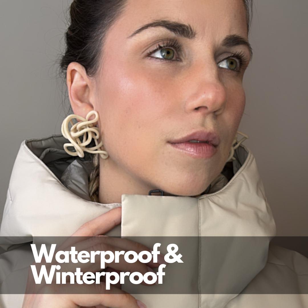 Model wearing Ivory Celestial Loops with text: Waterproof & Winterproof, showing year-round wear