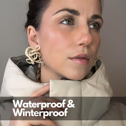 Model wearing Ivory Celestial Loops with text: Waterproof & Winterproof, showing year-round wear