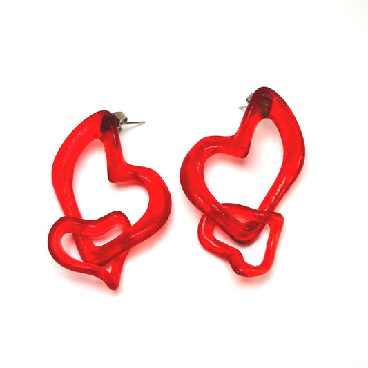 A pair of cherry red, heart-shaped earrings with an intertwined design, crafted from photopolymer resin and hypoallergenic stainless steel posts.