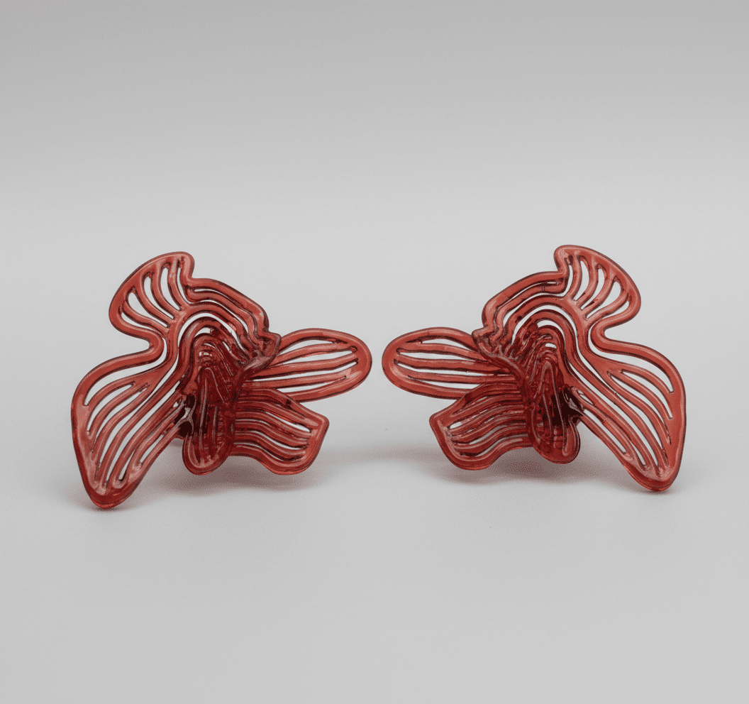 Close-up of red designer jewelry texture, showing the vibrant cherry red finish.