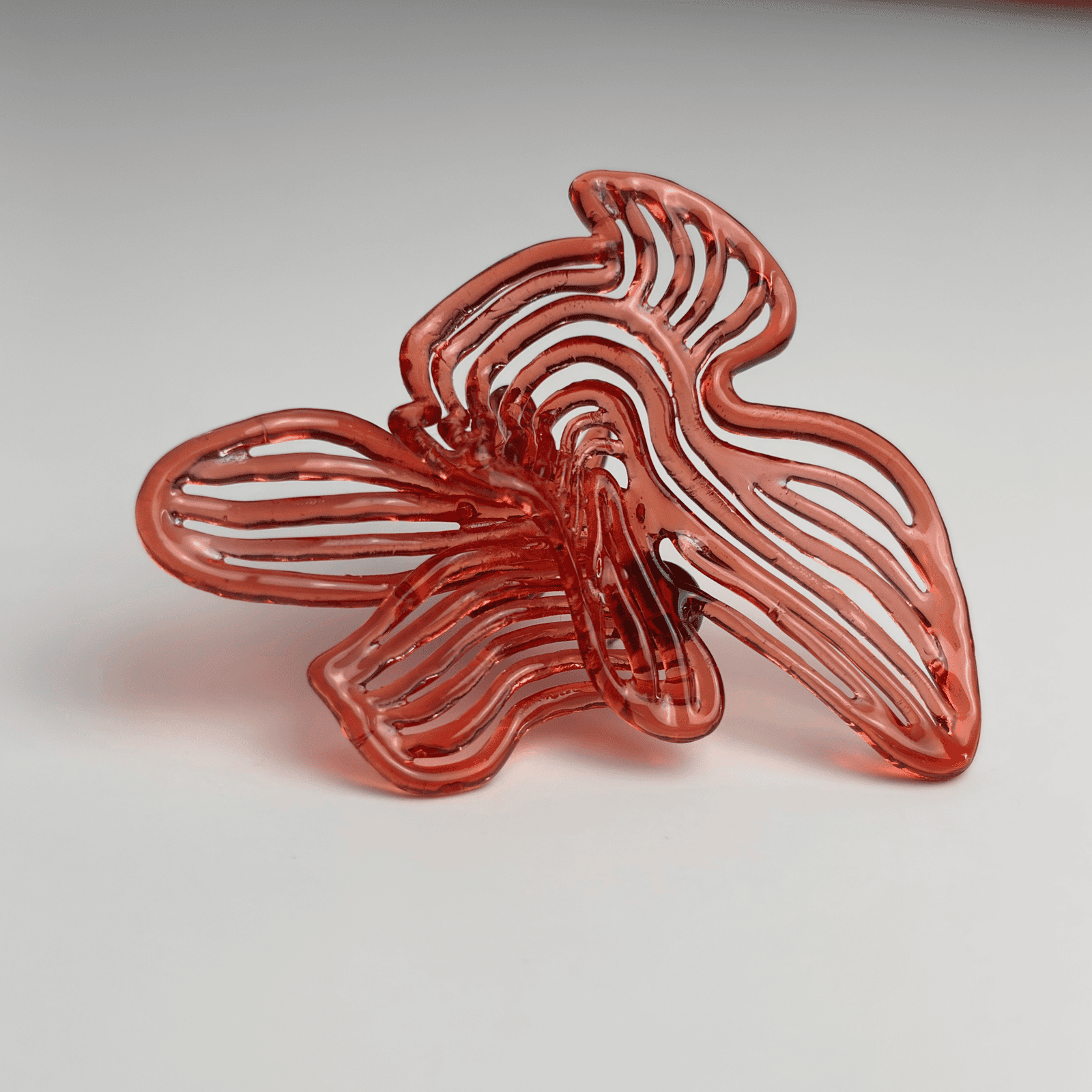 Single Cherry Red Rhythm earring, showcasing the detailed sculptural fashion statement jewellery piece.