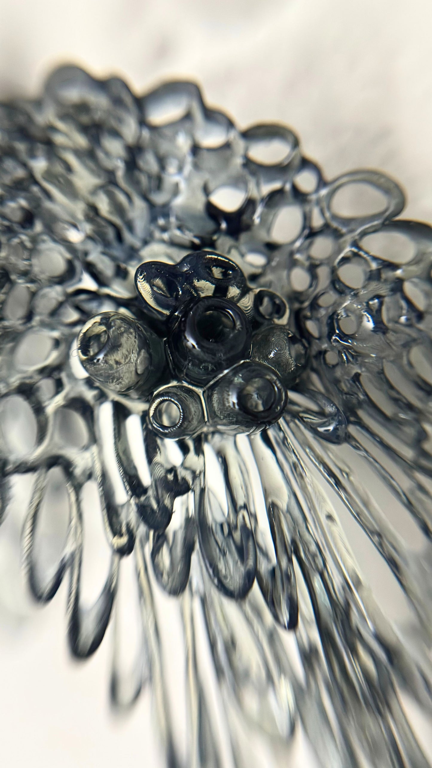 Extreme front close-up of a single black Coral Lace earring, full detail