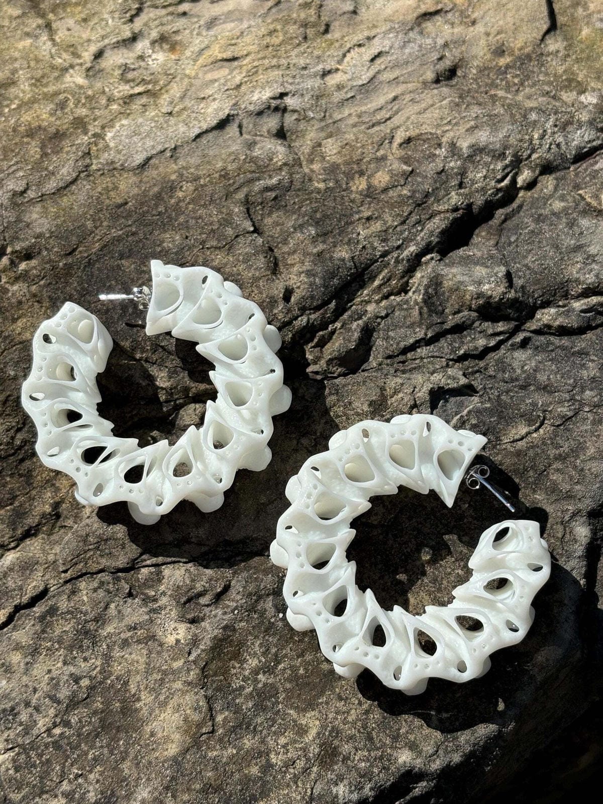 Nature inspired statement earrings styled flat on a clean background.