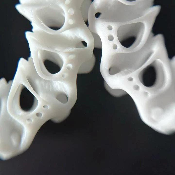 Close-up of sculptural resin hoops, highlighting the architectural coral detail.