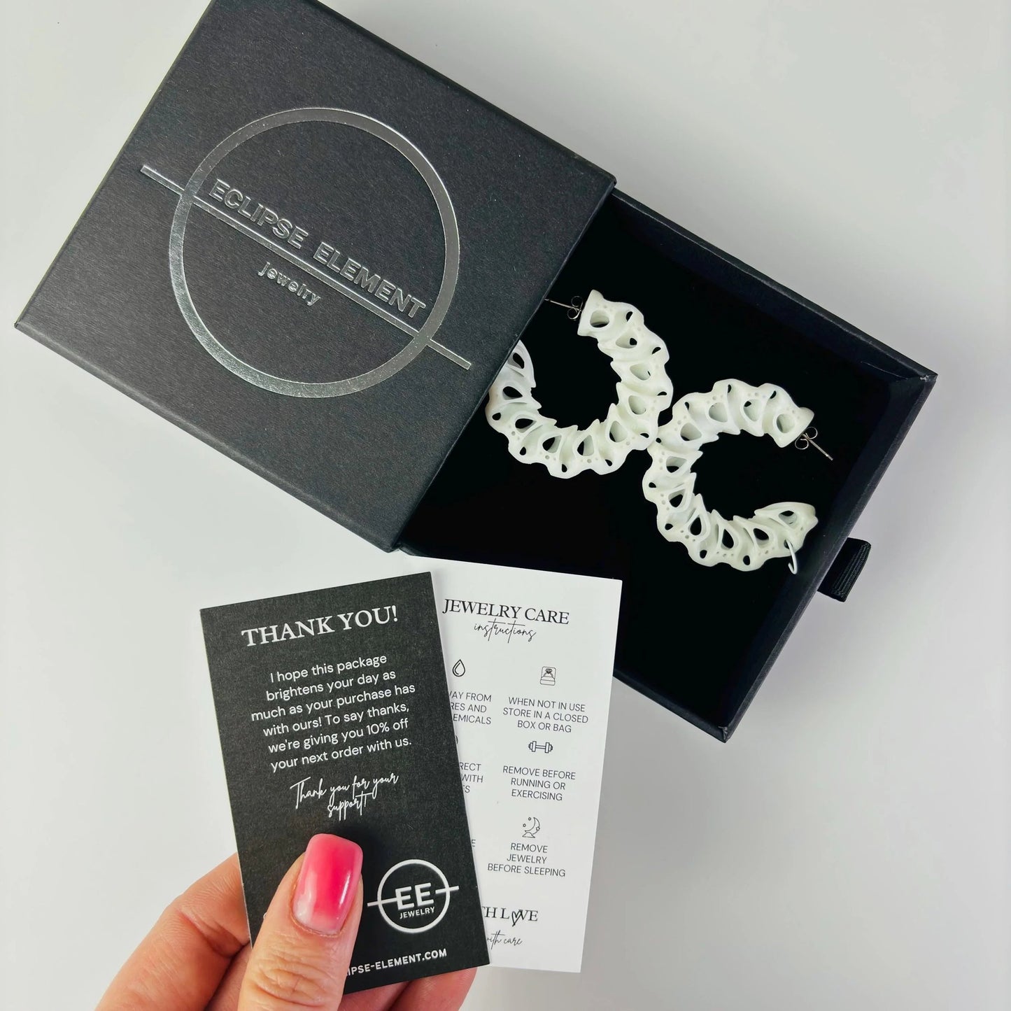 Coral color jewelry in branded packaging, ready to be gifted