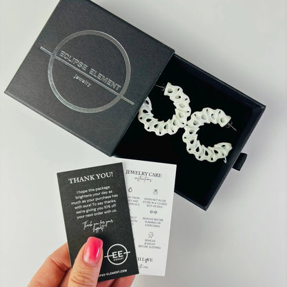 Coral color jewelry in branded packaging, ready to be gifted