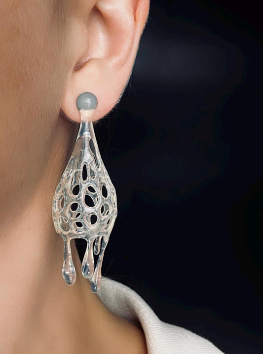 Close-up of a  crystal-inspired drop 3d printed earrings with a dark background