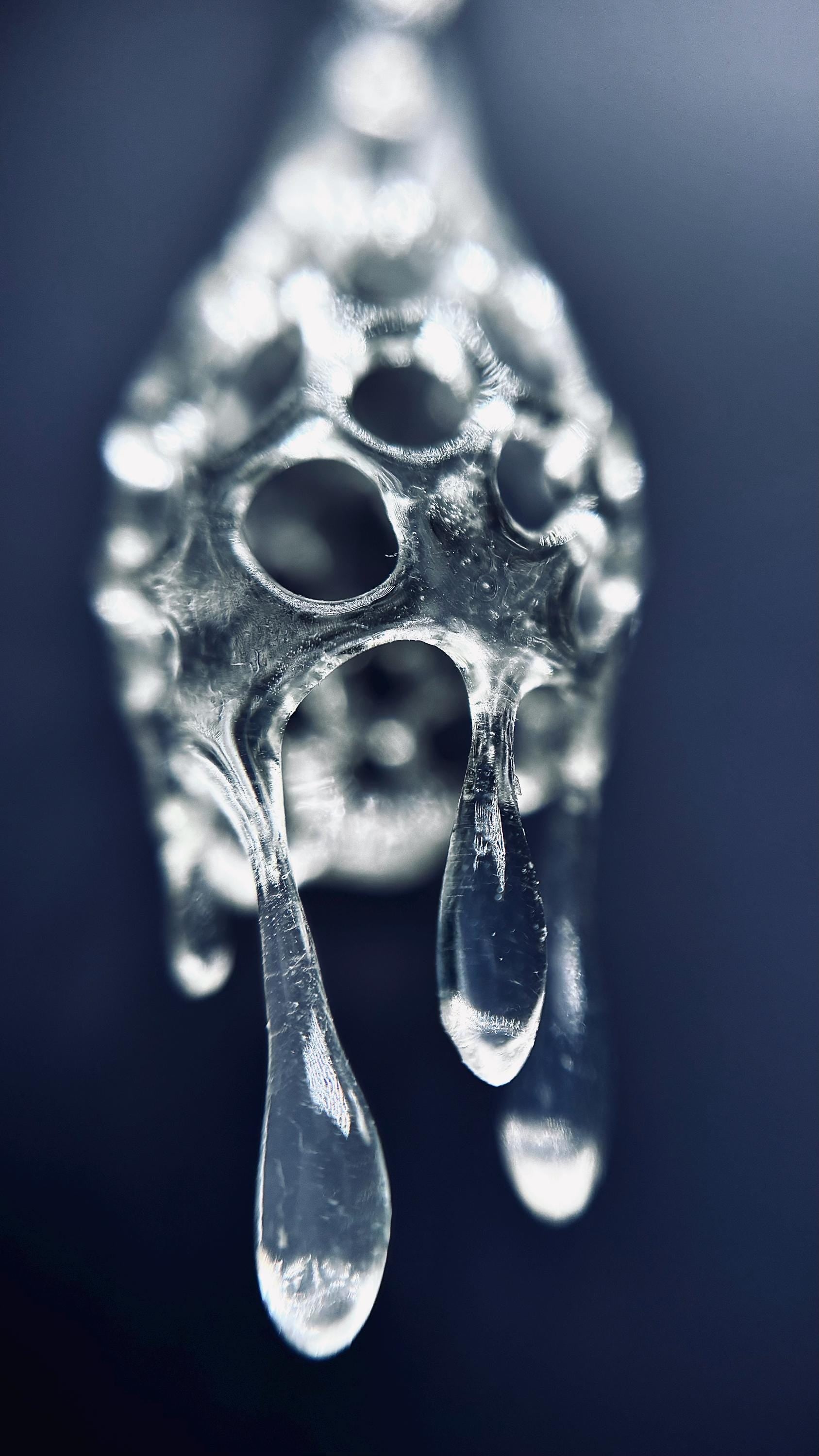 Close-up of a  crystal drop 3d printed earrings on a dark background