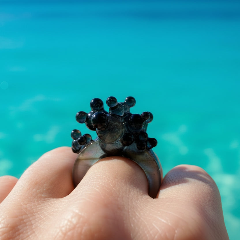 Dark Matter sculptural statement ring featuring a bold architectural design in glossy black.