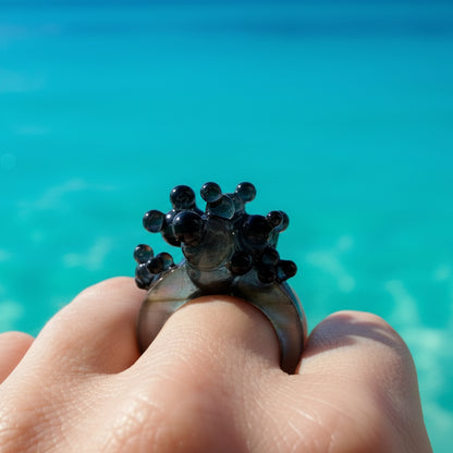 Dark Matter sculptural statement ring featuring a bold architectural design in glossy black.