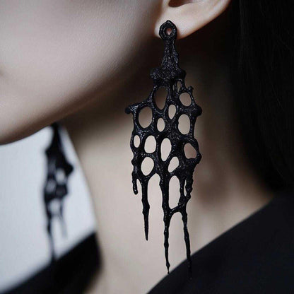 Goth earrings worn by a person, demonstrating the dramatic drop and black tie statement earrings look.