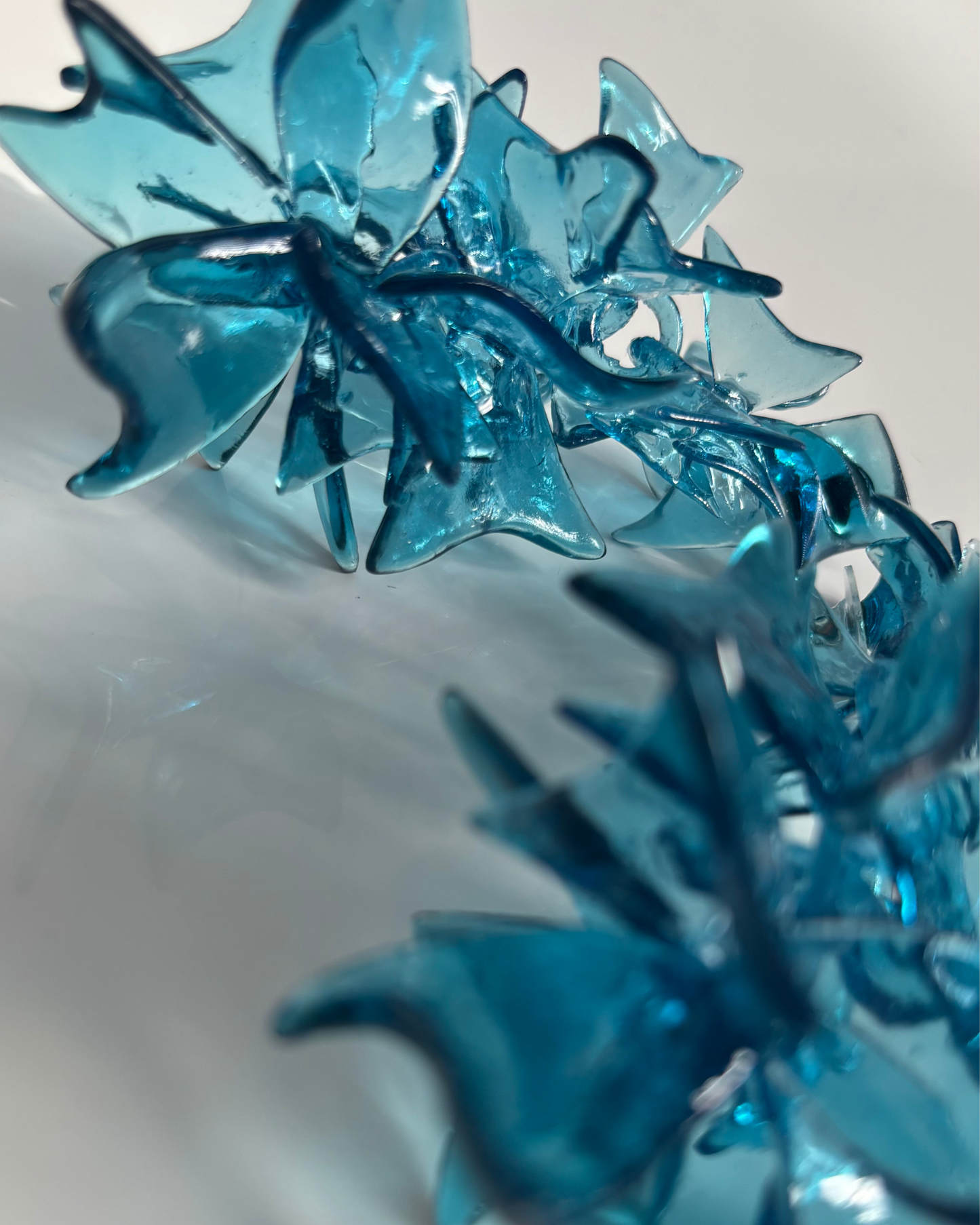 Close-up view of the intricate layered base structure of the earring