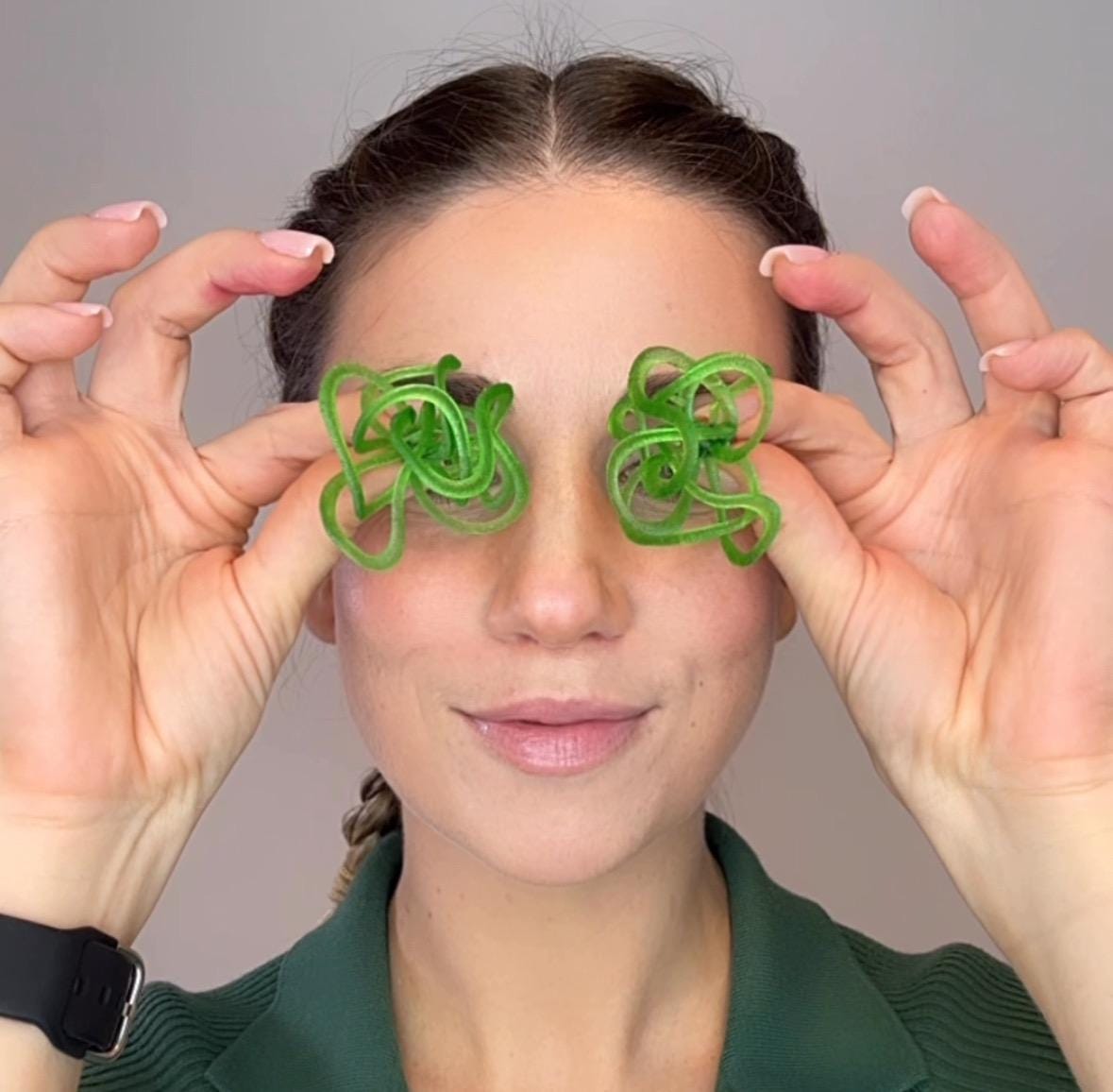 Person show green earrings