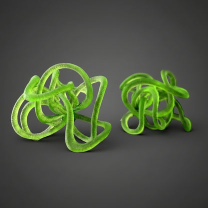 A pair of green, loop-shaped statement earrings against a black background.