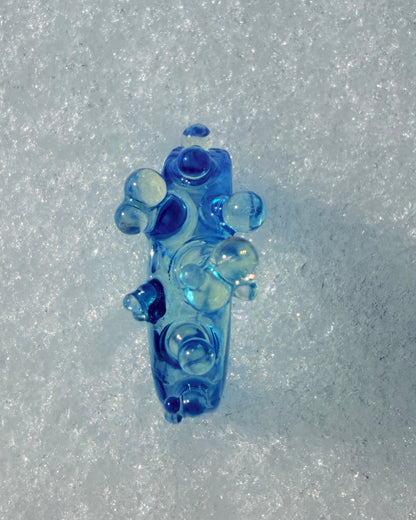 Extreme close-up of the Ice Blue Bubble Ring, highlighting the smooth matte finish and the organic "water bubble" geometry.