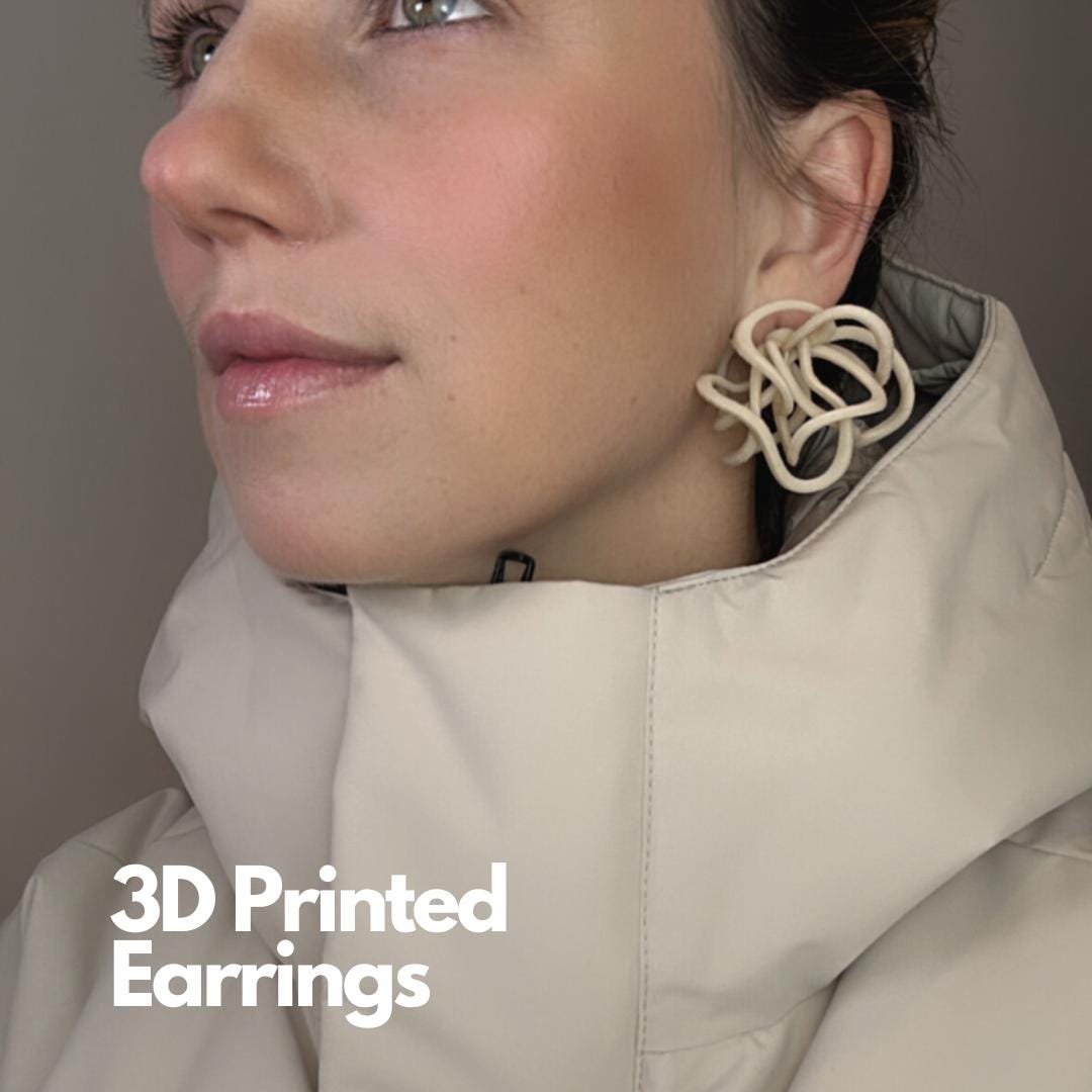 Close-up on model showing the lightweight nature of these modern statement earrings.