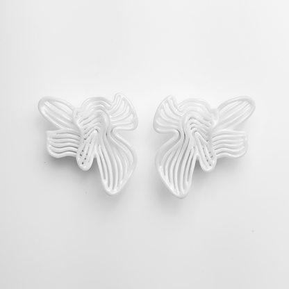 White large white floral statement earring on a light gray background