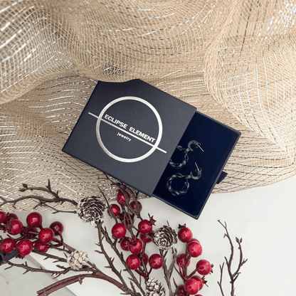 Studio shot of the infinity hoops, perfect jewelry for jumpsuit styling.