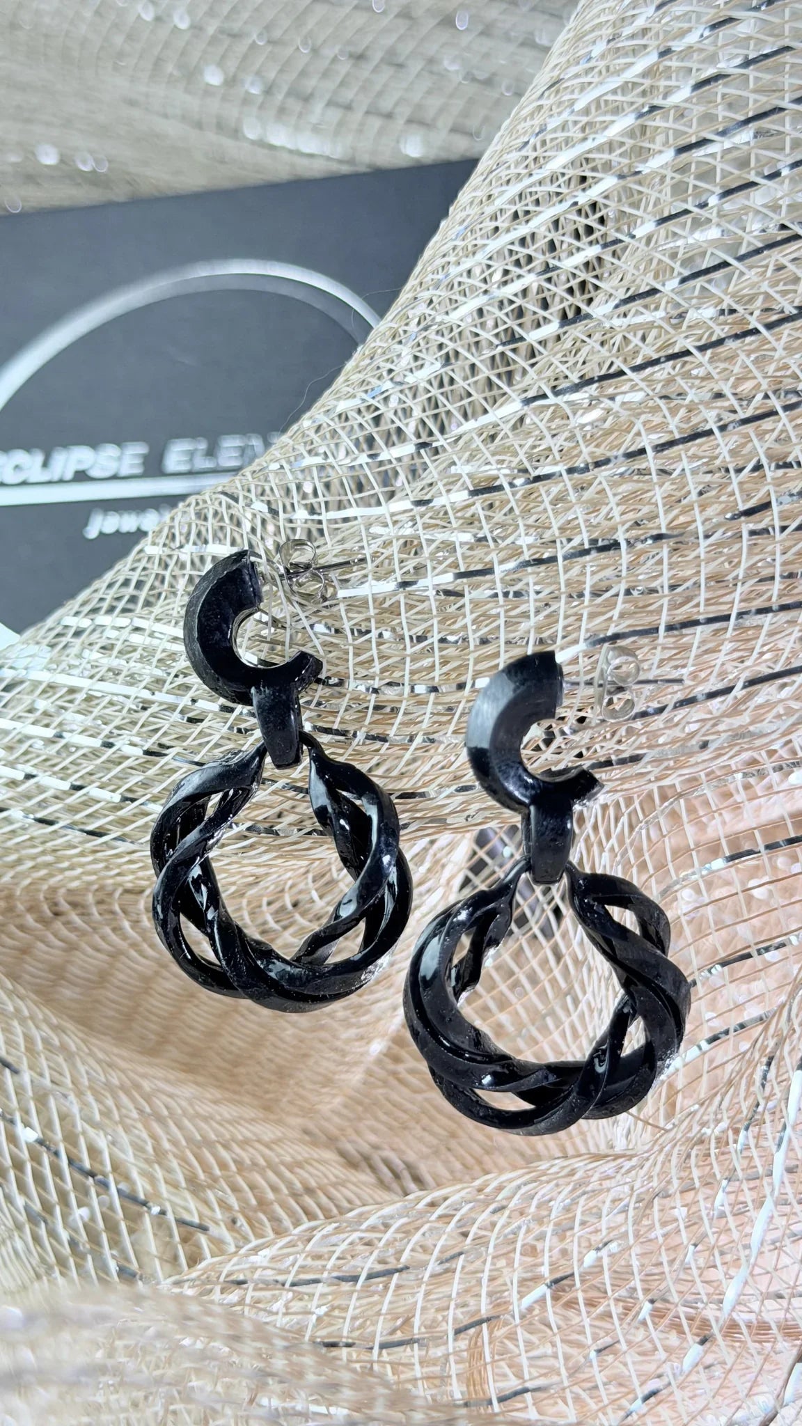 Top-down view of the noir infinity hoops, showing the architectural flow.