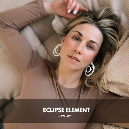 Profile view of model wearing geometric hoop earrings.