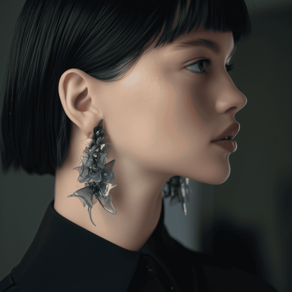 Model wearing floral statement earrings in a bold gothic style.