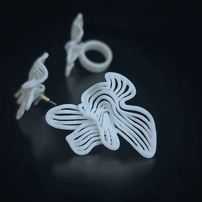 Close-up of the 3D printed jewelry texture on the white Rhythm set, emphasizing the art deco statement earrings design.