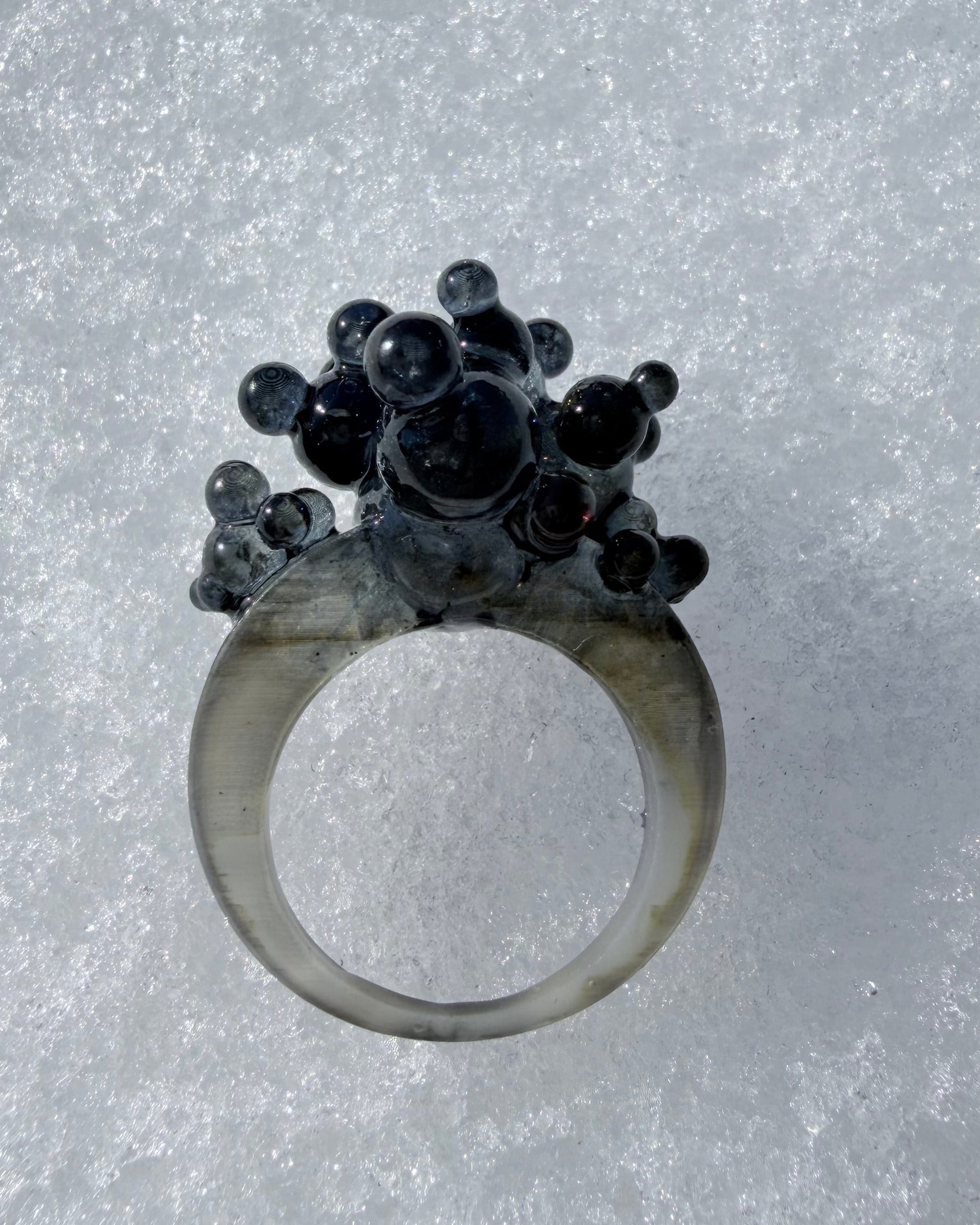 Side view of the Dark Matter ring, highlighting the organic flow and unconventional jewelry shape.