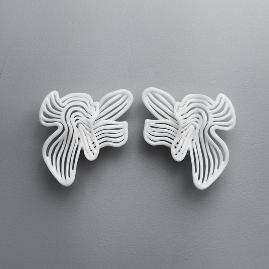 Two white floral-shaped 3d printed earrings on a gray background